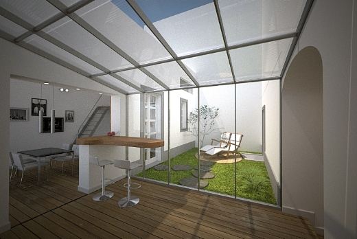 Cucina tutta in parquet con veranda vetrata